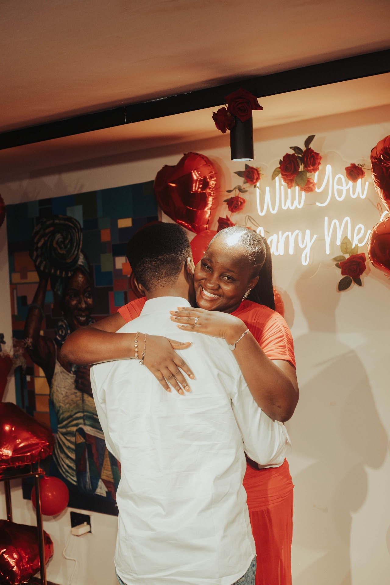 Fiye smiling brightly while hugging Kofo